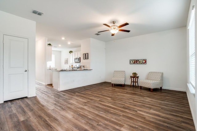 unfurnished room with dark hardwood / wood-style floors and ceiling fan