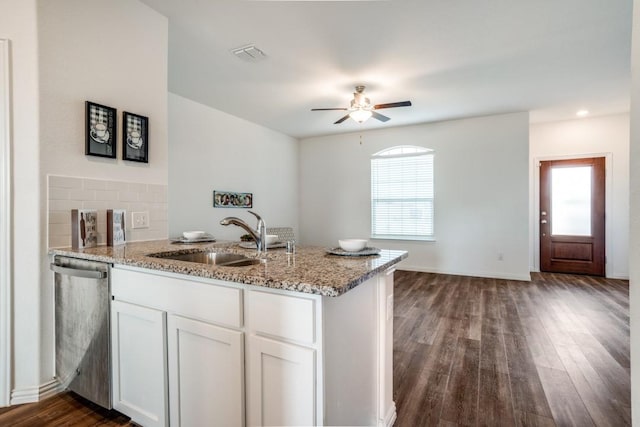 kitchen featuring white cabinetry, light stone countertops, sink, and stainless steel dishwasher