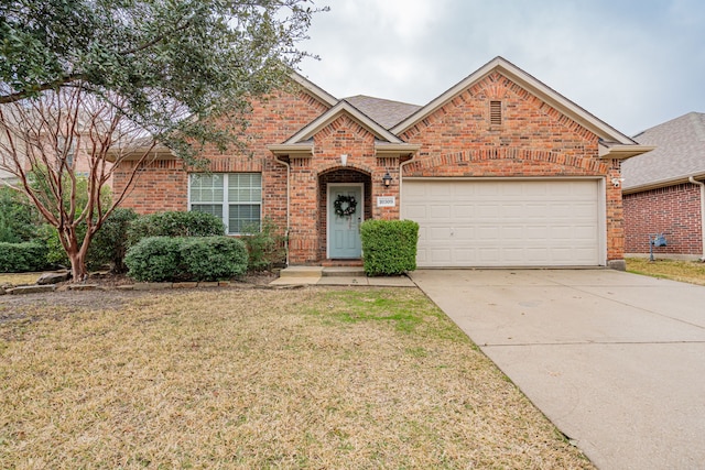 view of front of house featuring a garage and a front yard