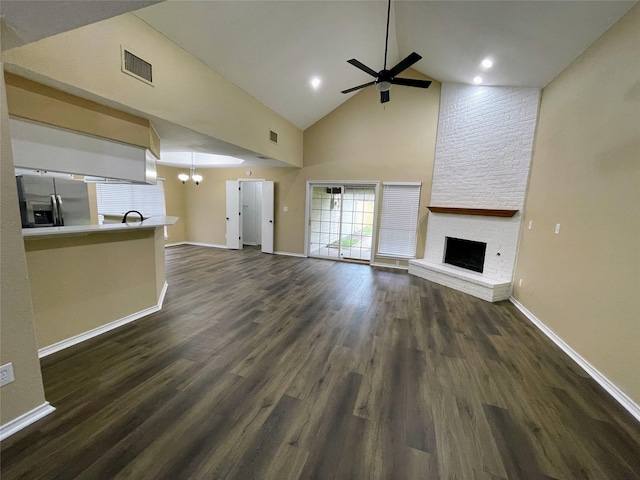 unfurnished living room featuring baseboards, a fireplace, visible vents, and dark wood-style flooring