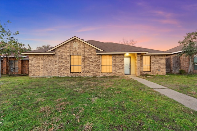 ranch-style house featuring a yard