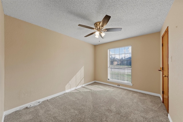 unfurnished room with ceiling fan, carpet floors, and a textured ceiling