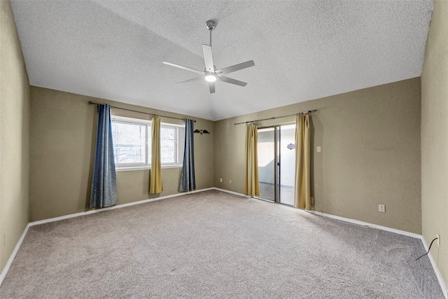 unfurnished room with ceiling fan, carpet flooring, vaulted ceiling, and a textured ceiling