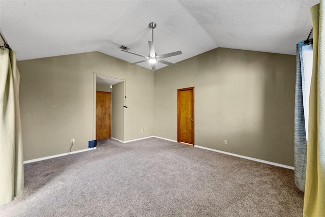 unfurnished bedroom featuring ceiling fan, lofted ceiling, carpet floors, and a textured ceiling