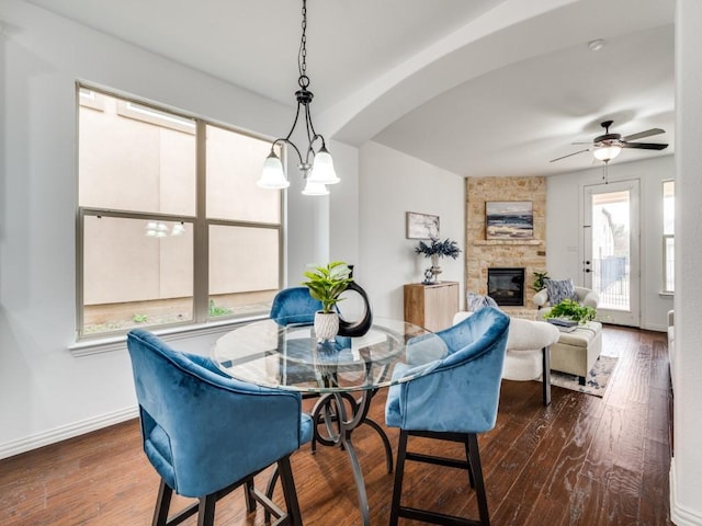 dining room featuring hardwood / wood-style flooring, ceiling fan, and a fireplace