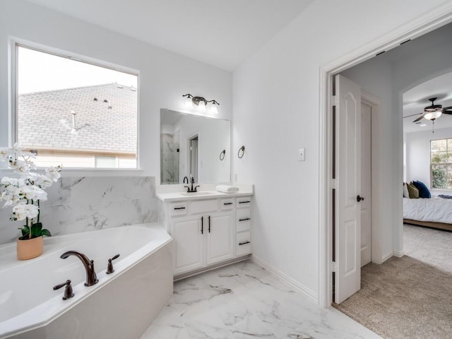 bathroom with vanity, a bath, and ceiling fan