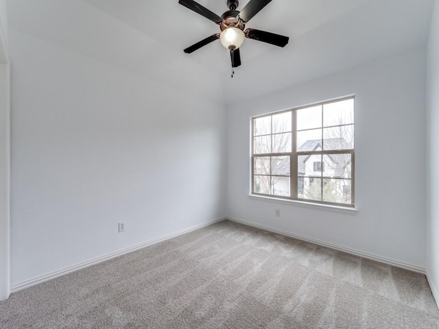 carpeted empty room featuring ceiling fan