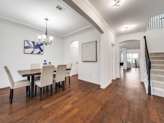 dining space featuring crown molding, a notable chandelier, and dark hardwood / wood-style flooring