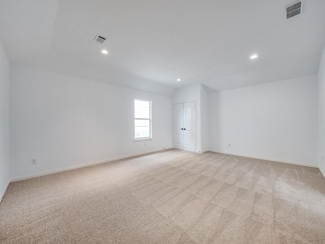 unfurnished room featuring light carpet