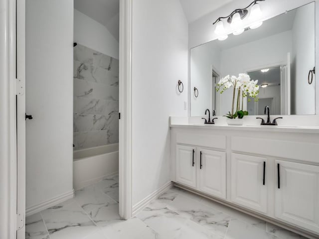 bathroom featuring tiled shower / bath and vanity