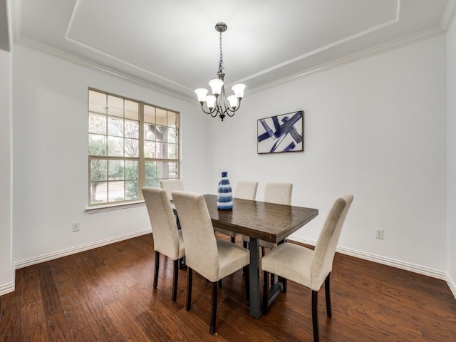 dining room with crown molding, dark hardwood / wood-style floors, and an inviting chandelier