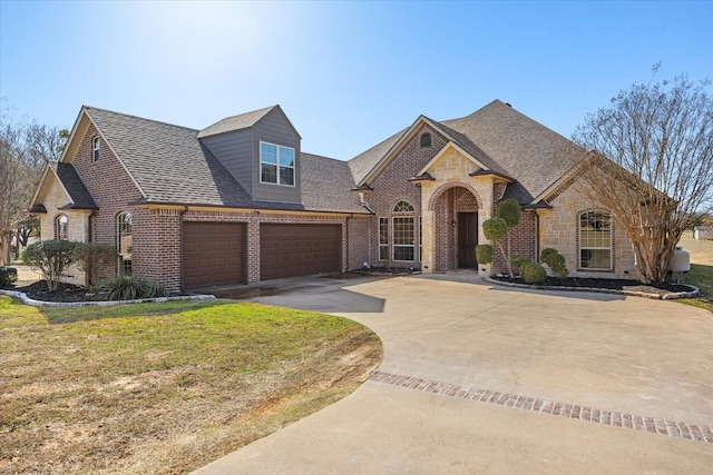 view of front of house featuring a garage and a front lawn