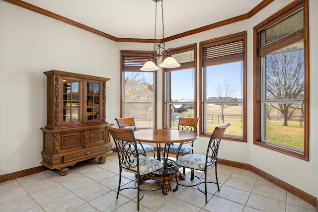 tiled dining space featuring crown molding