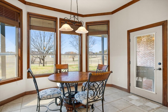 tiled dining space with ornamental molding and a wealth of natural light