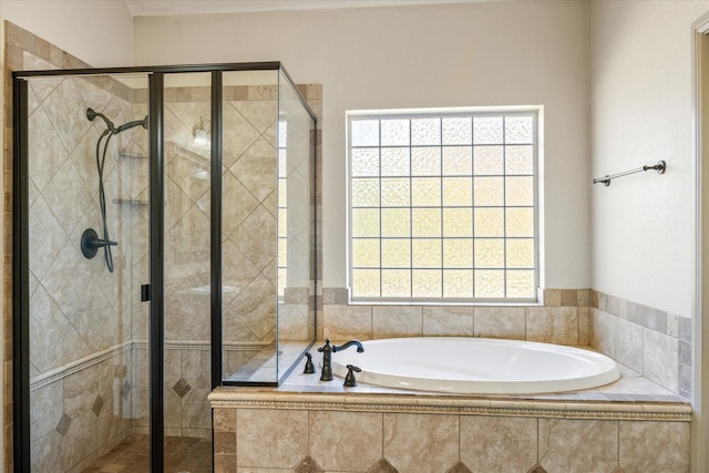 bathroom featuring shower with separate bathtub