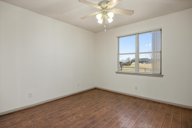 empty room with dark wood-type flooring and ceiling fan