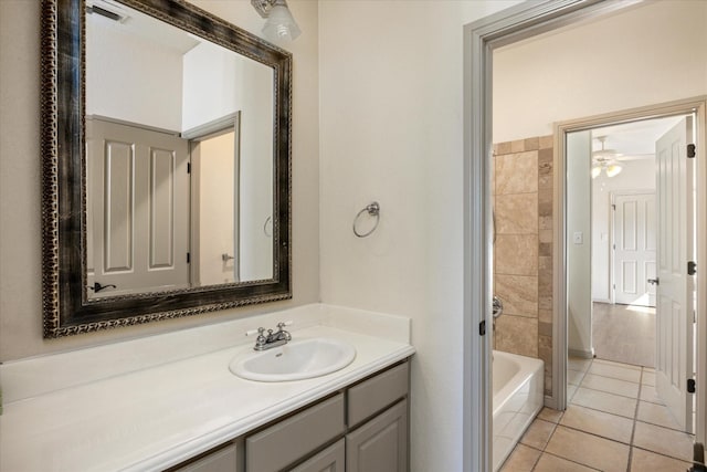 bathroom featuring tile patterned floors, vanity, and a bathing tub