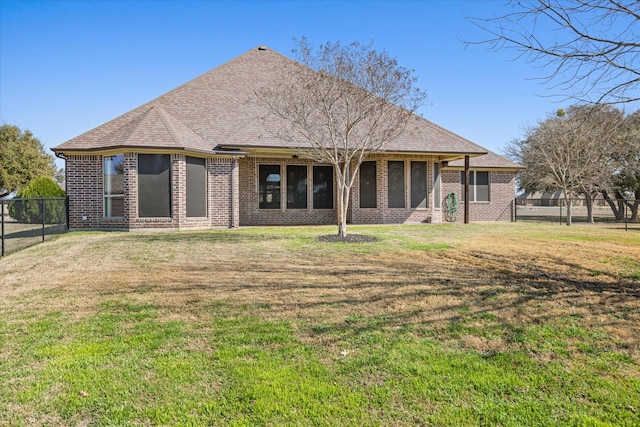 rear view of property with a yard