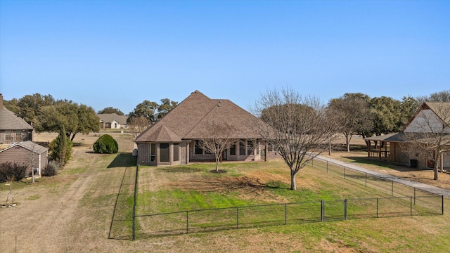 back of property featuring a yard