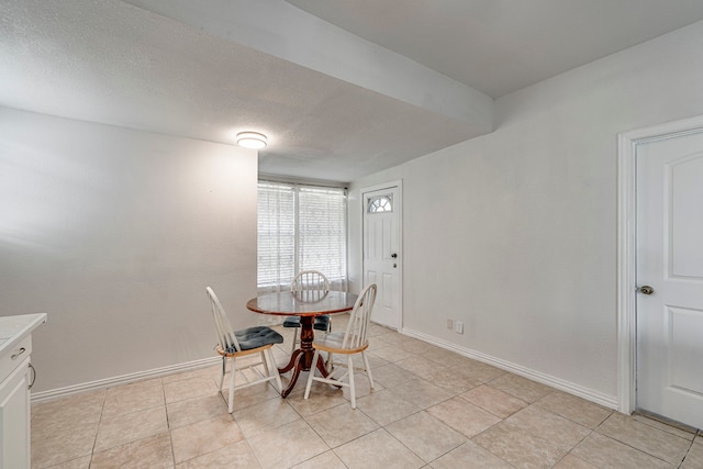 tiled dining room with a textured ceiling