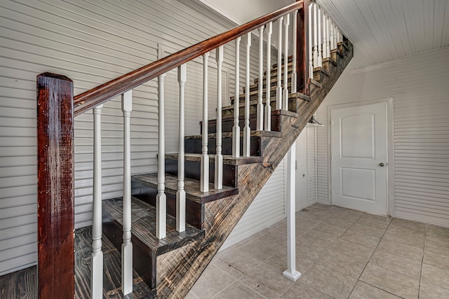 stairway with tile patterned floors