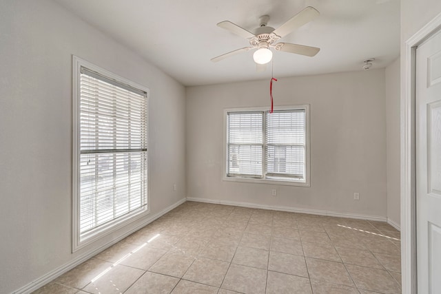 tiled empty room with ceiling fan