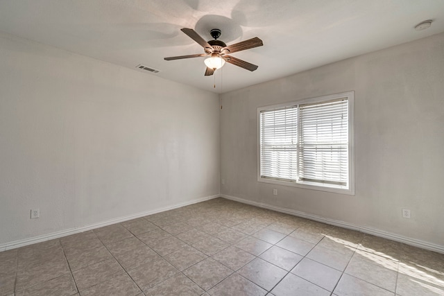 spare room featuring light tile patterned floors and ceiling fan