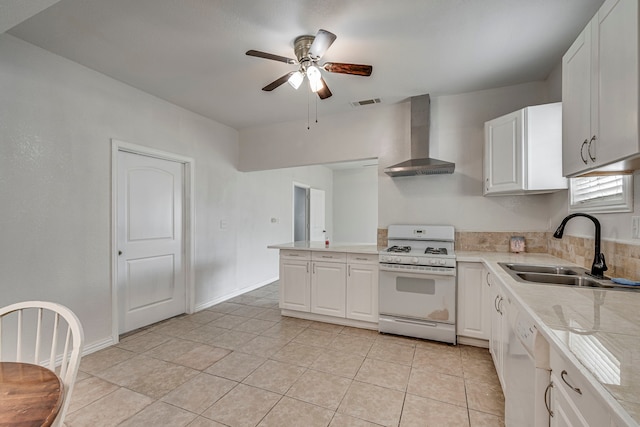 kitchen featuring sink, white appliances, ceiling fan, white cabinets, and wall chimney exhaust hood