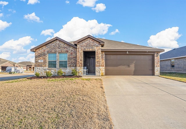 view of front of property with a garage and a front yard