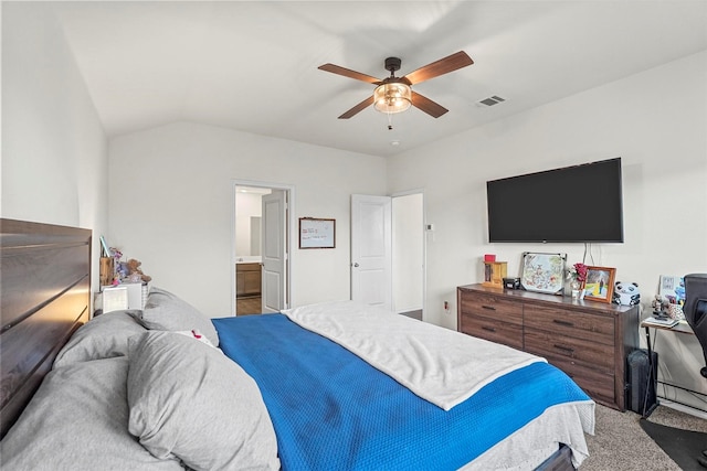 bedroom with ensuite bathroom, vaulted ceiling, and ceiling fan