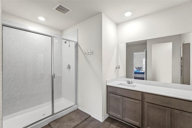 bathroom with vanity, hardwood / wood-style floors, and walk in shower