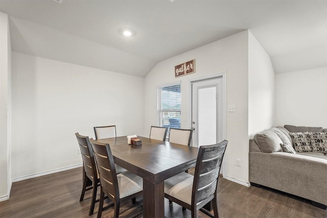 dining area with lofted ceiling and dark hardwood / wood-style flooring