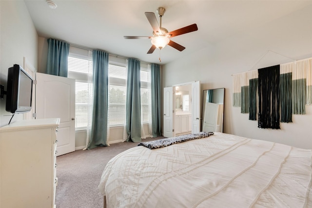 bedroom featuring ceiling fan, light colored carpet, and ensuite bathroom