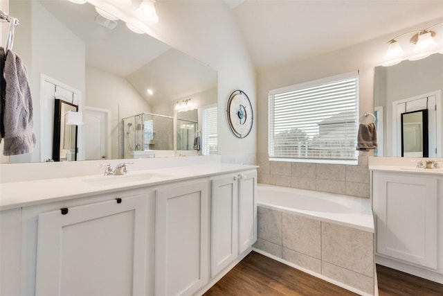 bathroom with vanity, plus walk in shower, vaulted ceiling, and hardwood / wood-style floors