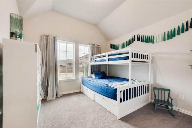 carpeted bedroom with lofted ceiling