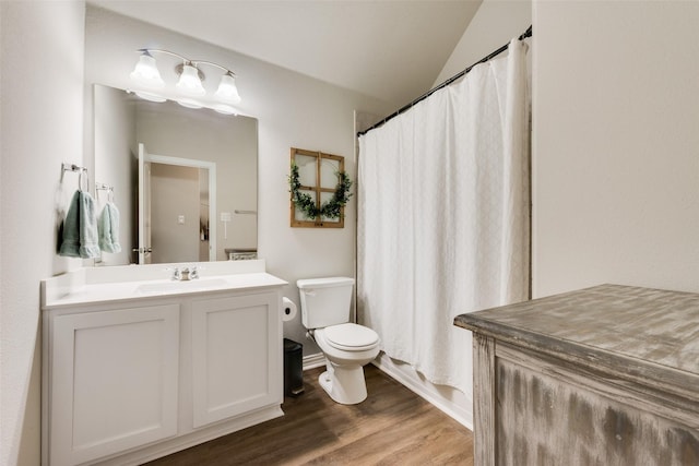 full bathroom with shower / tub combo, vanity, toilet, and hardwood / wood-style floors