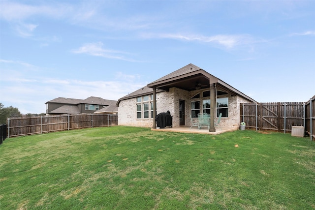 back of property featuring a yard and a patio area