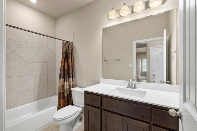 full bathroom with shower / tub combo with curtain, vanity, and toilet