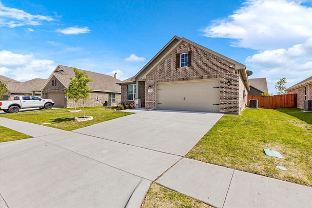 view of front property featuring a garage, central AC, and a front yard