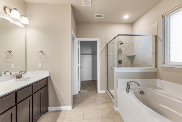 bathroom featuring vanity, tile patterned floors, and shower with separate bathtub