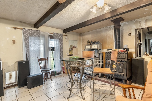 tiled dining room featuring beam ceiling, a chandelier, and a textured ceiling