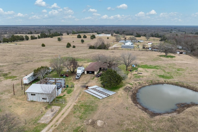 birds eye view of property with a water view and a rural view