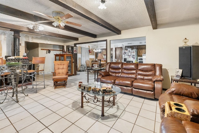 tiled living room with ceiling fan, beam ceiling, and a textured ceiling