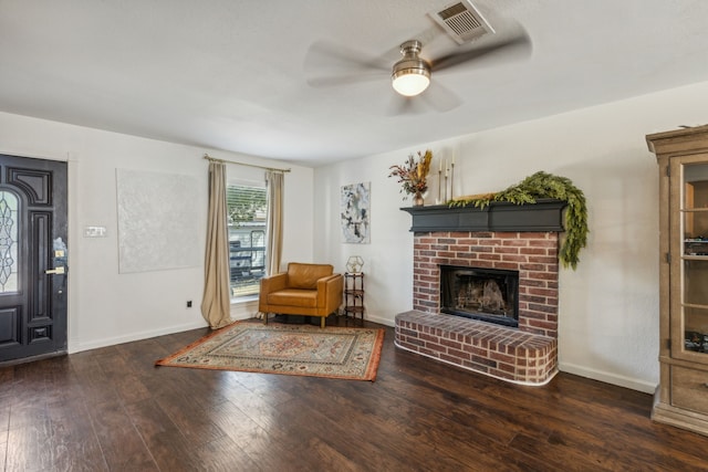 interior space with dark wood-type flooring, ceiling fan, and a fireplace