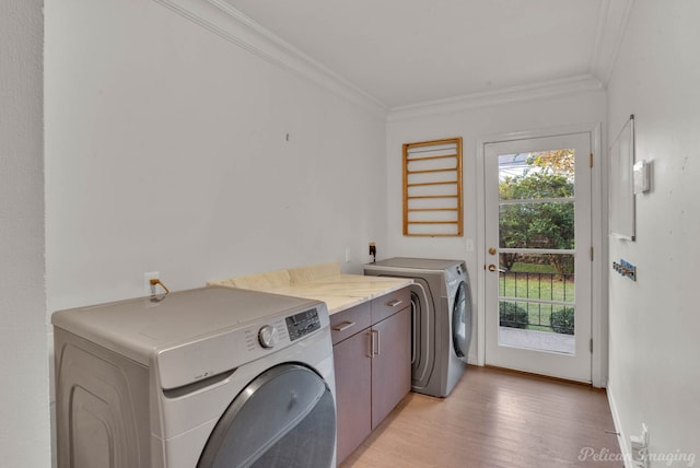 clothes washing area with cabinets, ornamental molding, plenty of natural light, and independent washer and dryer