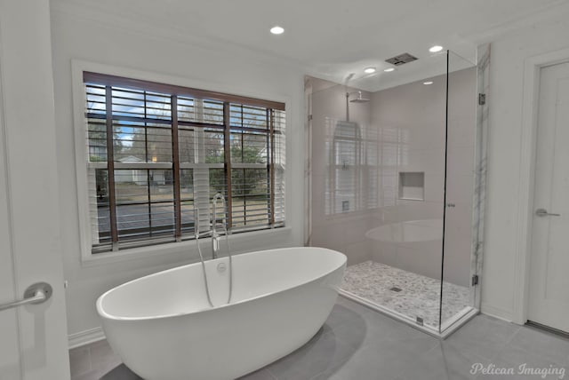 bathroom with separate shower and tub and tile patterned floors