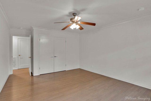 unfurnished bedroom with crown molding, light hardwood / wood-style floors, a closet, and ceiling fan