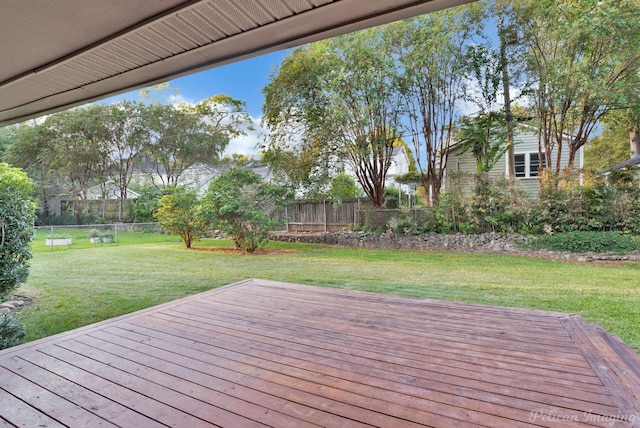 wooden terrace featuring a lawn