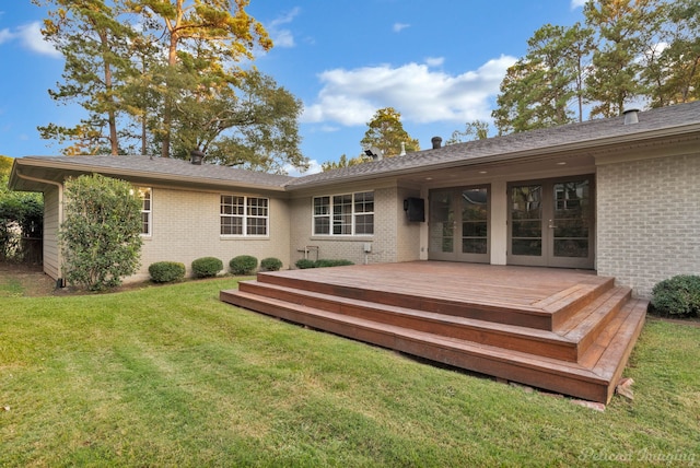 rear view of house featuring a lawn and a deck