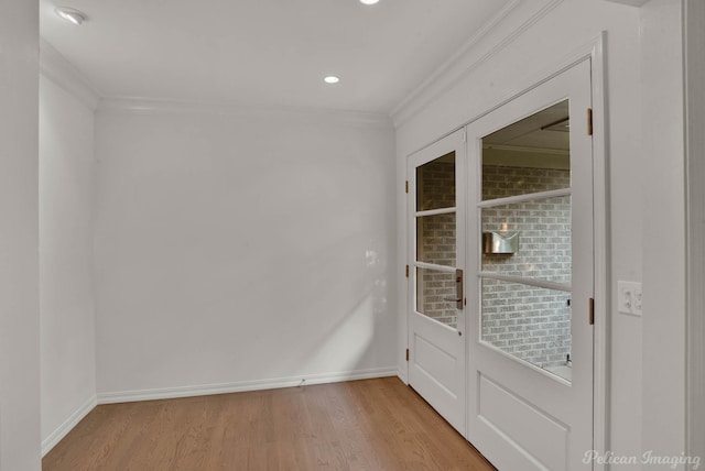 unfurnished room with crown molding and light wood-type flooring